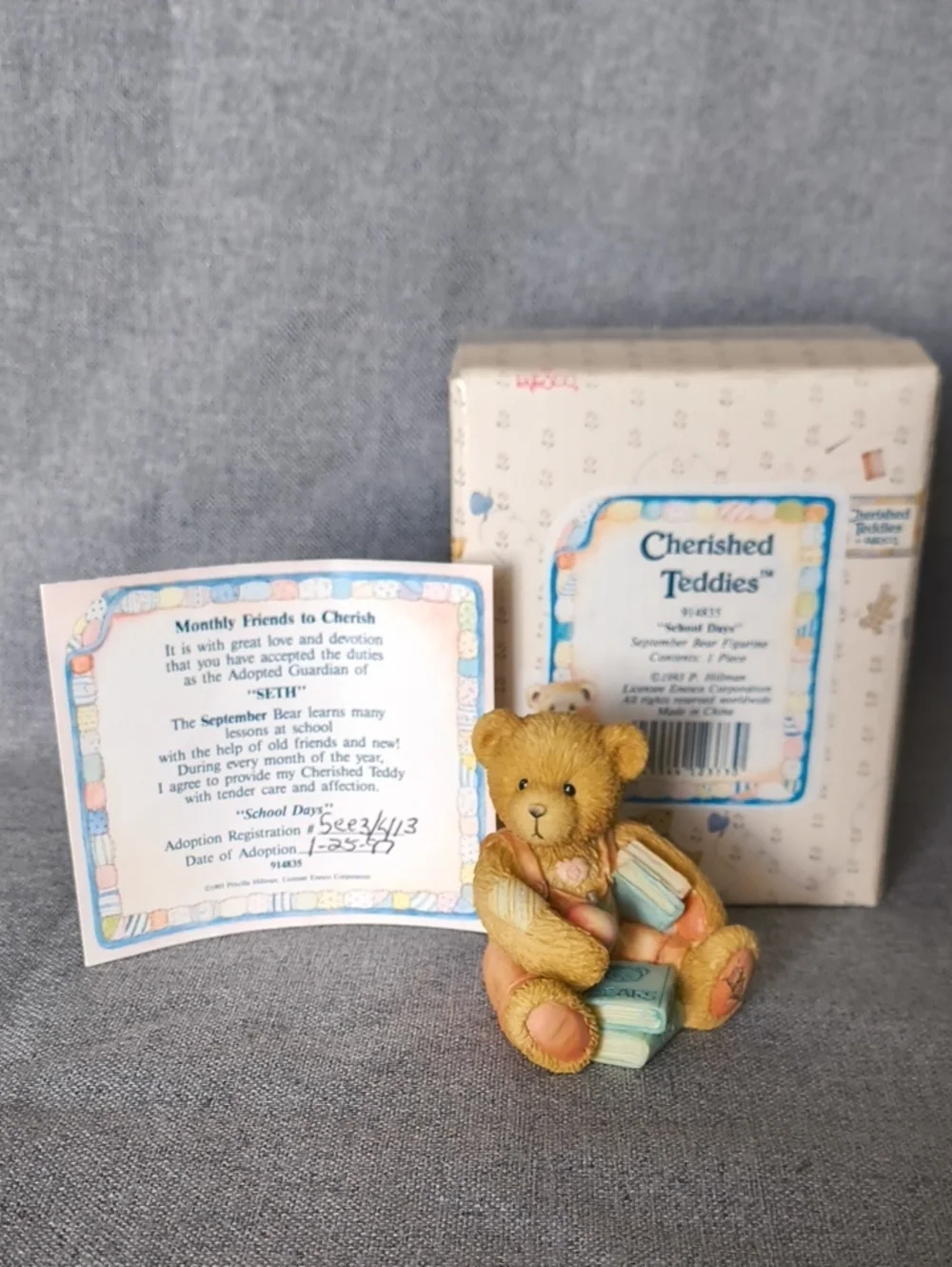 Cherished Teddies tan bear figurine with pastel blue and pink accents